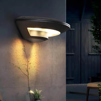 weatherproof outdoor wall light with warm white lighting in garden
