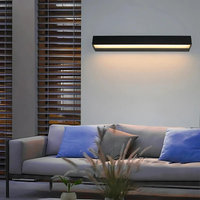A stylish and energy-efficient modern outdoor wall light illuminating a garden