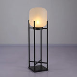 Modern outdoor solar lantern illuminating a garden pathway