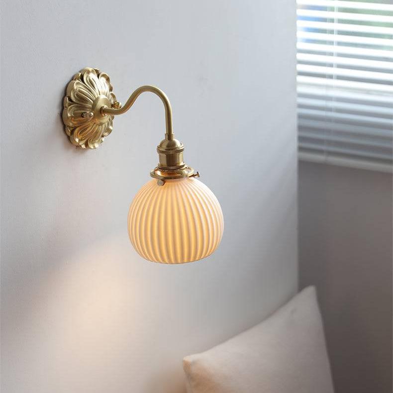 Decorative ceramic wall light with antique brass finish and wall sconce design