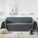 A variety of sofa throw covers and velvet couch cover displayed on a sofa