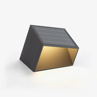 A solar garden light illuminating a pathway in an outdoor setting