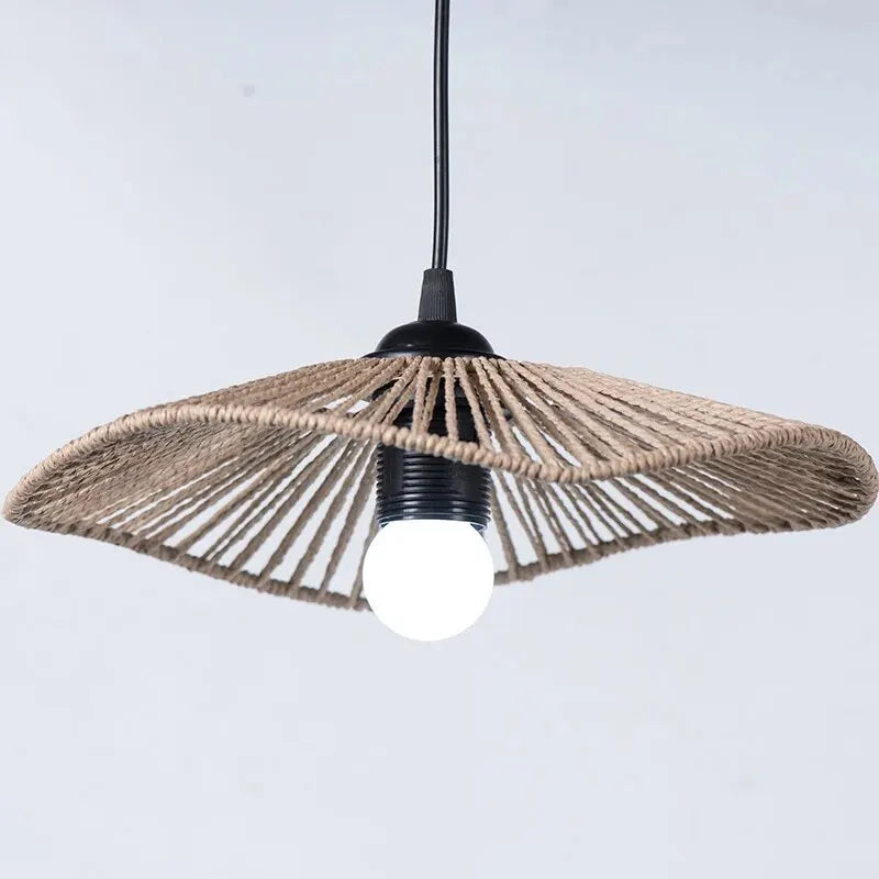 A large woven rattan lamp shade hanging from the ceiling