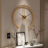 A stylish modern wall clock with a gold finish, perfect for living rooms