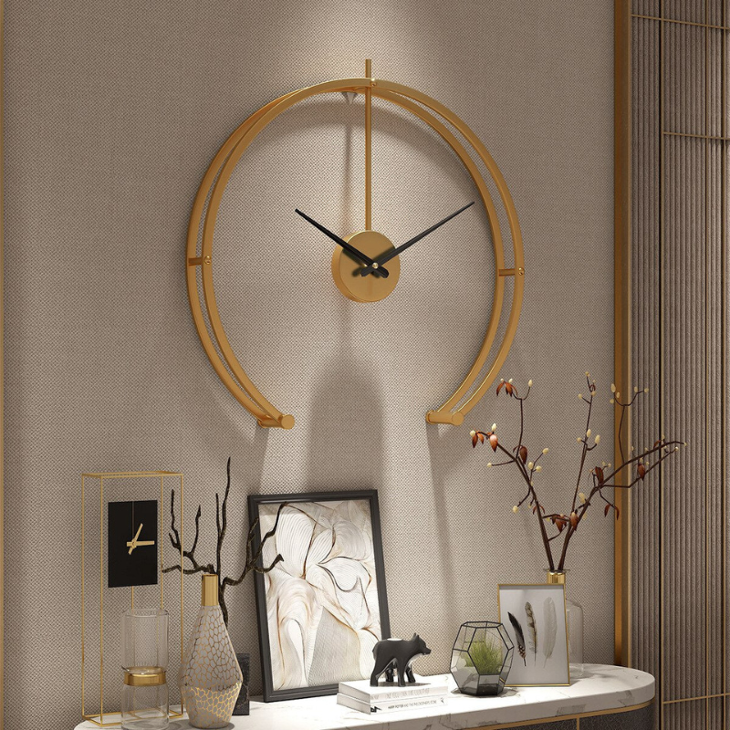 A stylish modern wall clock with a gold finish, perfect for living rooms