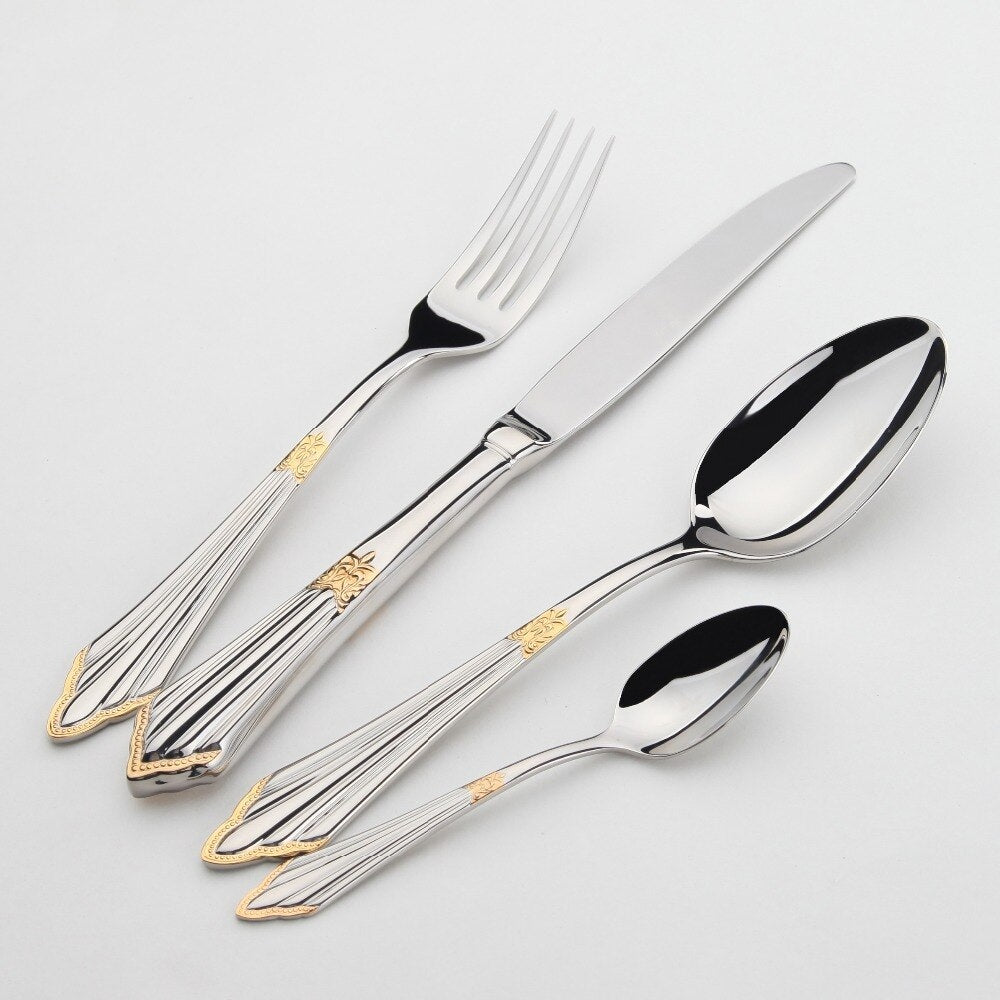A 24 piece gold and stainless steel cutlery set arranged neatly