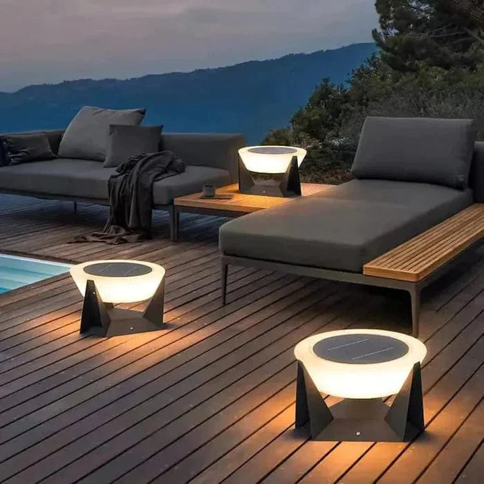 An outdoor setting featuring solar garden light, solar pathway lighting, and solar powered LED fixture