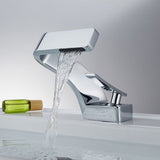 A sleek chrome waterfall bathroom tap installed on a bathroom sink