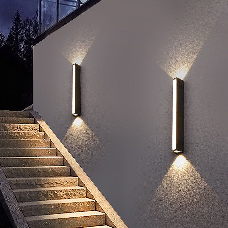 Bright and stylish led outdoor light illuminating garden, mounted as outdoor wall lamp