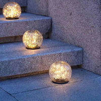 Solar powered outdoor light illuminating garden