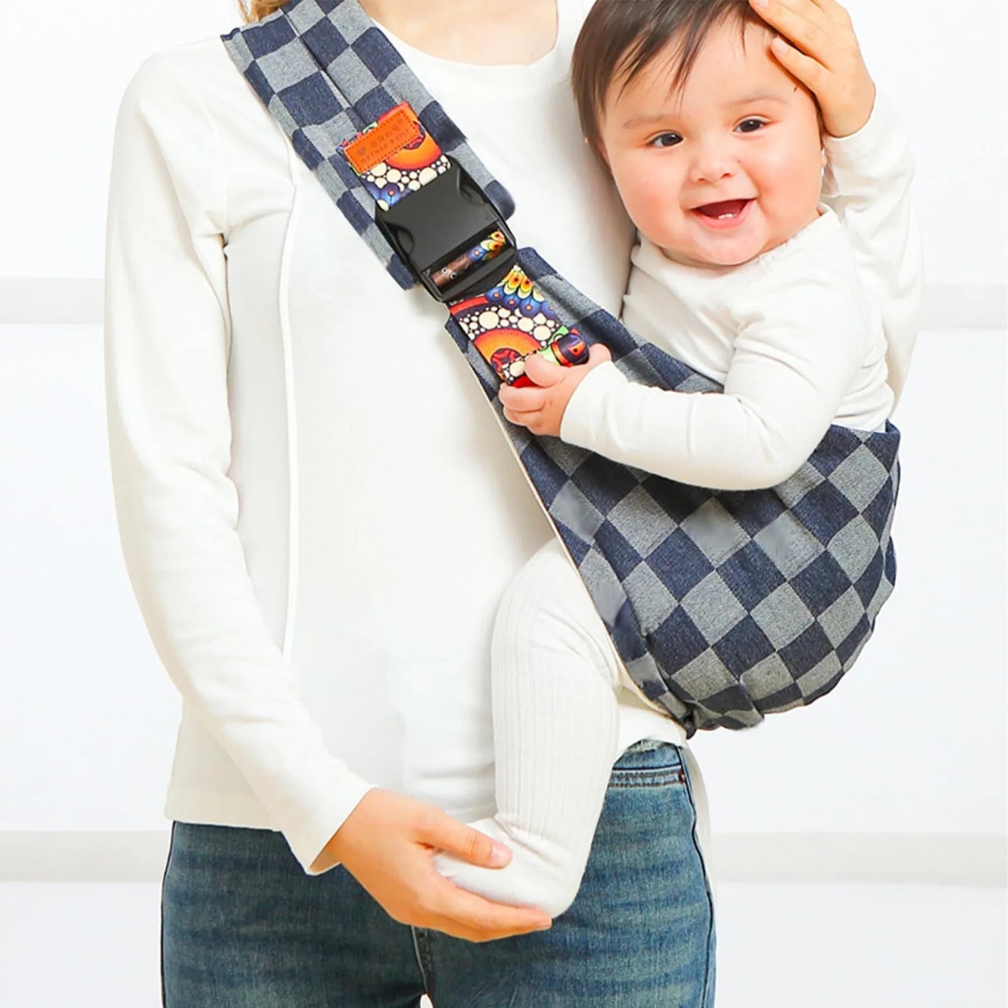 Parent comfortably using a baby carrier wrap with infant