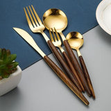 A complete gold cutlery set displaying forks, knives, and spoons