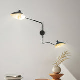 A modern black adjustable wall light installed indoor showcasing its versatile design