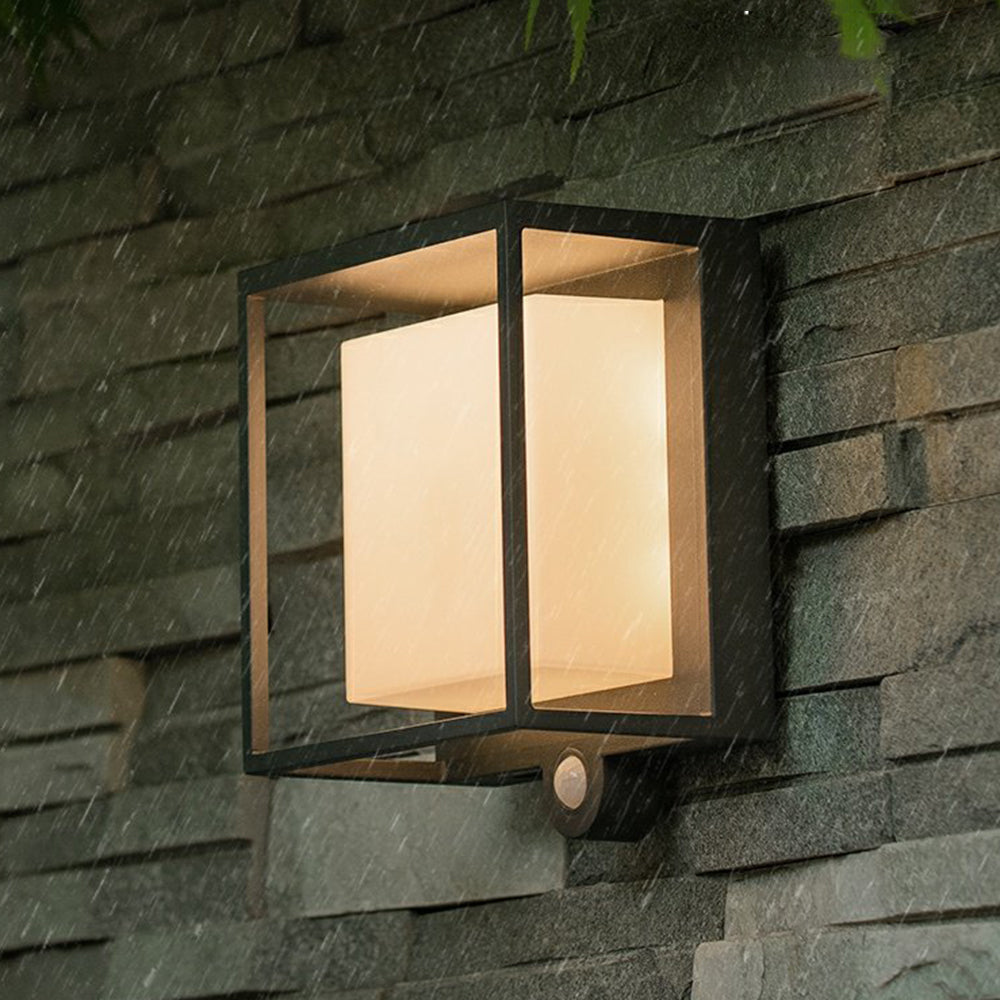 Modern solar wall light for outdoor use illuminating garden