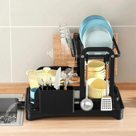 Two tier dish rack with dishes drying on a kitchen countertop