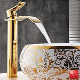 Gold bathroom tap with a waterfall design