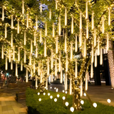 An array of outdoor string lights elegantly illuminating a garden setup with LED patio lighting
