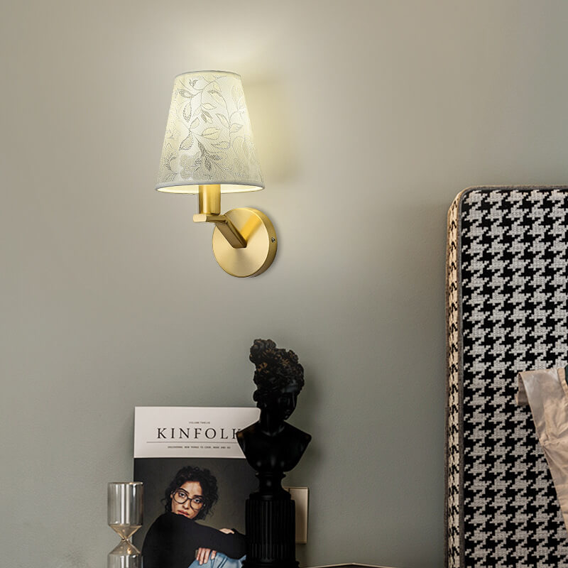A decorative wall lamp with a floral fabric lampshade